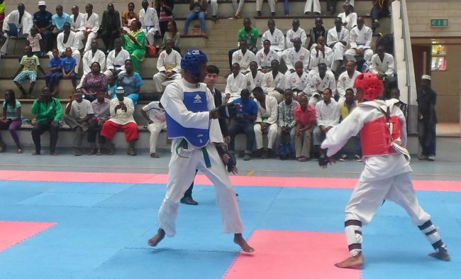 Kenya's Boniface Njagi (blue) and Mike Macharia square it off during their sparring bout at the Mombasa Open Tong-IL-Moo-Do International championship at Aga Khan Academy on Sunday.