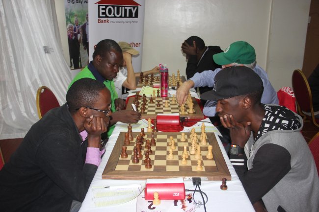 Harold Wanyama battles it out with Haruna Nsubuga in round six of the Equity Bank Chess Open. (Photo Courtesy)