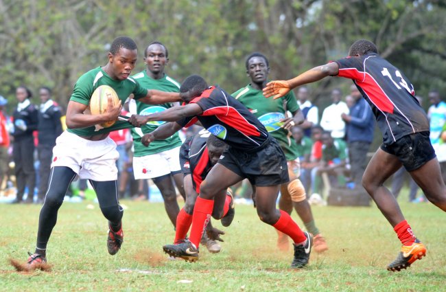 Kakamega High School Franklin Shiveka hands off an opponent from Galana Secondary School in one of the pool matches. They play Upper Hill School in the semis. (Photo by Shutterspeed)