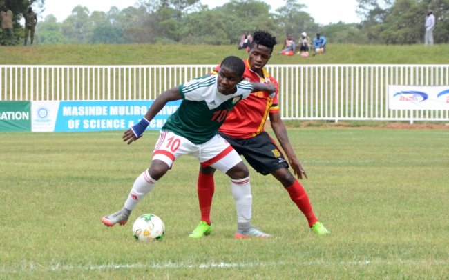 Burundi's Shassir Nahimana shields the ball away from Uganda Cranes' Milton Karisa. (Photo by Alex Wafula)